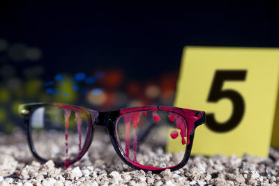 Close-up of sunglasses on glass table