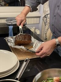 Midsection of man preparing food in kitchen