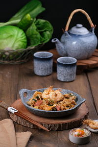 Flatlay angle view of food on table, pangsit tumis serving on stone bowl