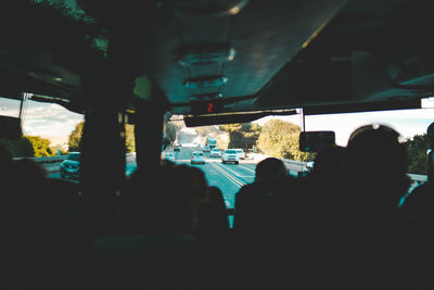 Silhouette people in bus on road