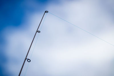 Low angle view of rope against blue sky