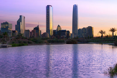 View of city at waterfront during sunset