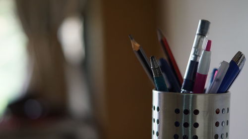 Close-up of writing instruments in desk organizer