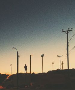 Silhouette of street light against clear sky