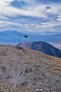 Scenic view of land and mountains against sky