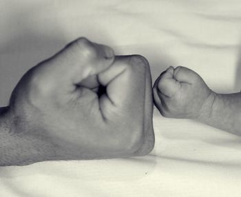 Close-up of couple hands against white background