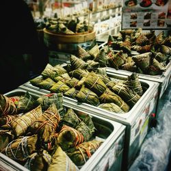 Close-up of food wrapped in leaves for sale at market stall