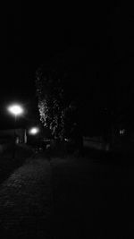 Illuminated street light against clear sky at night