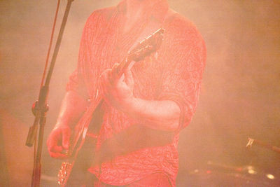 Close-up of woman standing on orange surface