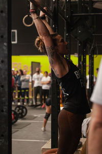 Midsection of man with arms raised