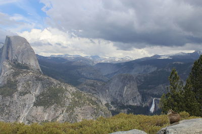 Scenic view of mountains against cloudy sky