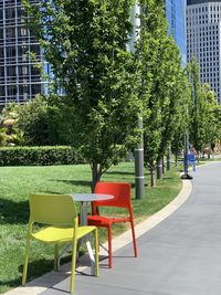 Empty chairs against trees in park