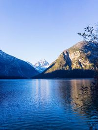 Scenic view of lake and mountains against clear sky