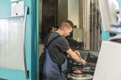 Man working at machine in factory