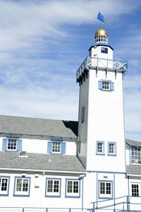 Low angle view of lighthouse against sky on sunny day