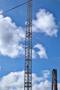 Low angle view of crane against sky