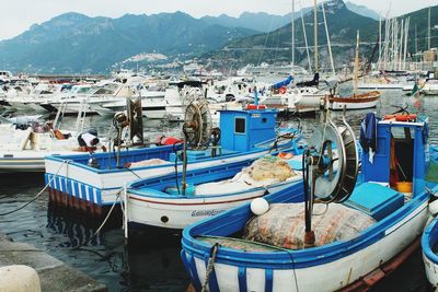 Boats moored at harbor in city