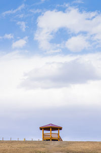 Pavilion on landscape against sky