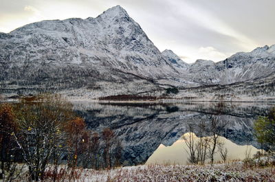 Mountain lake like the perfect nature mirror located between snowy mountains