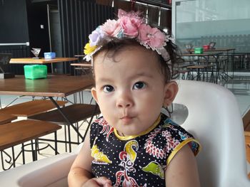 Portrait of cute girl sitting outdoors