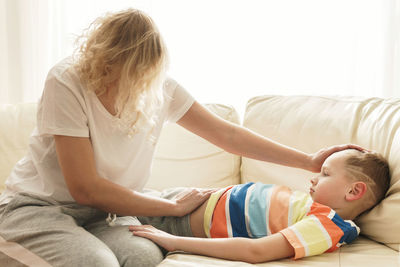 Side view of mother and daughter at home