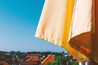 Low angle view of flags against clear sky