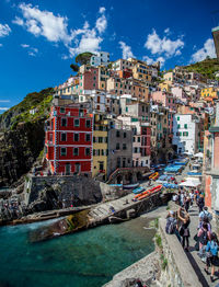 Panoramic view of people on rock against sky