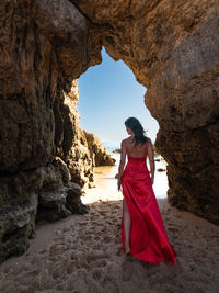 Rear view of woman standing on rock