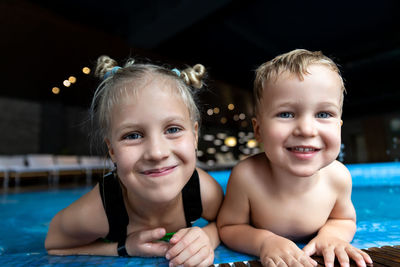 Close-up portrait of cute girl in swimming pool