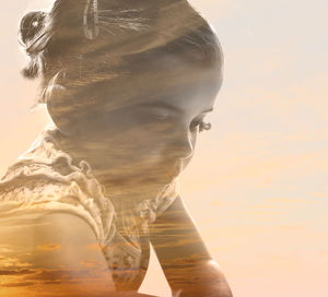 Double exposure of girl and sky during sunset