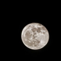 Low angle view of moon against dark sky