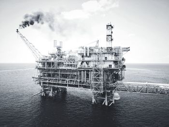Lifeguard hut in sea against sky