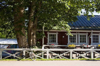 Chairs and table at sidewalk cafe against sky