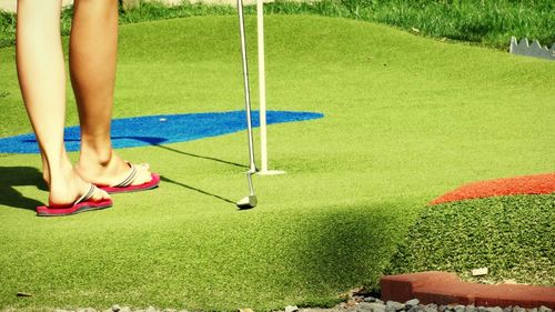 Low section of woman standing on grass