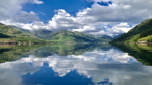 Scenic view of lake and mountains against sky