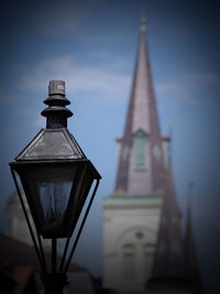 Low angle view of cross on building against sky