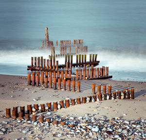 Lifeguard hut on beach against sky
