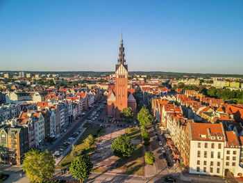 High angle view of city buildings against clear sky