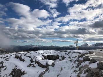 Scenic view of snow covered mountains against sky