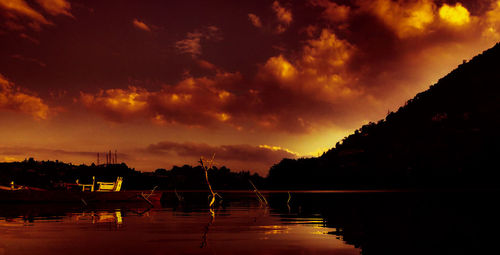 Scenic view of silhouette trees against sky at sunset