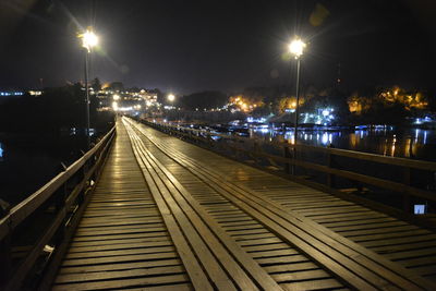 Railroad tracks in city at night