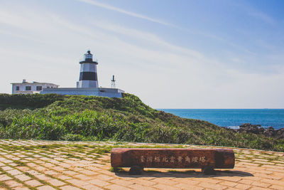 Lighthouse on sea against clear sky