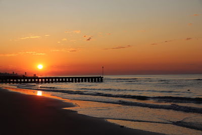 Scenic view of sea against romantic sky at sunset