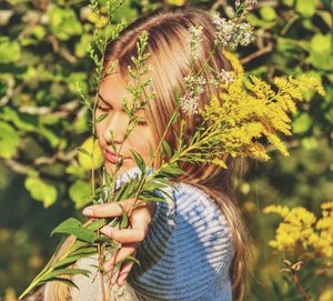 Portrait of woman with leaves outdoors