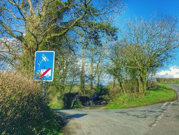 Road sign against blue sky