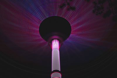 Low angle view of illuminated pole and roof