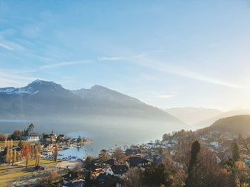 Town by mountains against sky