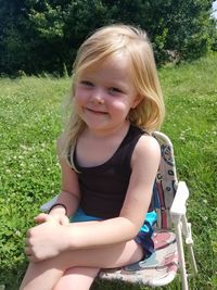 Portrait of smiling girl sitting on grass
