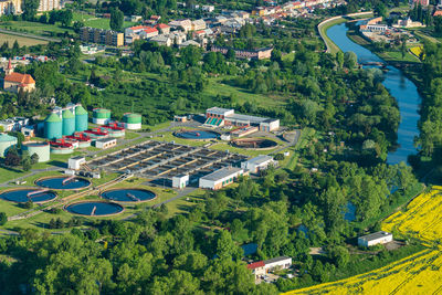 Aerial view of sewage treatment plant near the river and residential area