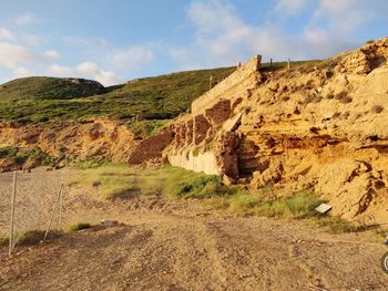 View of rock formations on landscape against sky